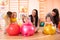 Mothers with happy babies doing exercises with gymnastic ball at fitness class. Concept of caring for the baby`s health.