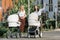 mothers walking with baby strollers on street woman