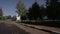 Motion along Road Past Factory Buildings Trees