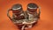 Motion around glass spice shakers in wicker basket on orange