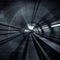 Motion Blur Abstract - in an underground tunnel heading towards a light. Black and white.