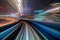 Motion blur of a city and tunnel from inside a moving monorail in Tokyo