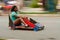 Motion Blur Of Girl Steering Car In Soap Box Derby