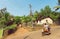 Motion blur from motorbike with tourists driving on village in popular Goa state, India. Rural landscape.