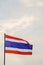 Motion and blur, the Thai flag fluttering atop the flagpole represents the Thai nation that knows love and unity. The colors of