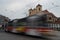Motion blur tram crossing a square