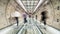 Motion blur of unidentified Asian people walking in subway tunnel walkway. Underground public transportation