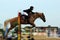 Motion blur unidentified equestrian rider show jump horse trying to overcome hurdles at Malaysia sport, Sukma in Pahang