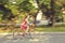 Motion blur. young woman in a dress rides a bike in a summer park