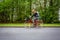 Motion blurred female biker on a city street,