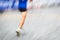 Motion blurred runner\'s feet in a city environment