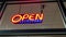 Motion of business store open sign display on the window during the night