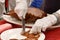 Motion of chef cutting roasted duck into a plate for customer