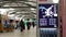 Motion of direction sign and passengers with luggage inside YVR airport