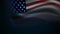 Motion graphic of a fluttering American flag set against a dark background