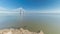 Motion from the low to high tide next to Vasco da Gama Bridge in Parque das Nacoes timelapse in Lisbon, Portugal.