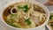 Motion of people eating pork with noodle soup