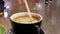 Motion of people putting cream and stirring coffee