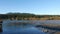 Motion of people walking on dock with river reflection shadow