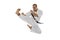 In motion. Portrait of one caucasian sportsman training isolated over white background. Karate, judo, taekwondo sport