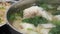 Motion of seafood dumpling soup on table inside restaurant