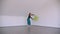 Motion shoot of young beautiful talented female performing an emotional dance with a picture leaning on the wall in the