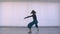 Motion shoot of young pretty flexible female performing an emotional dance in the empty room indoors in a flat