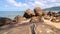 Motion Slider pan and tilt Timelapse video of beautiful tropical sea in summer season with rocks in the foreground Blue sky white