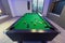 Motion Snooker Pool Billiards green table with complete set of balls in a middle of a game in a modern games room