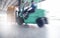 Motion speed blur of forklift driver loading shipment goods into container truck