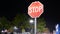 Motion of stop sign in front of parking lot at raining night