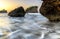 Motion waves on stones at the beach.