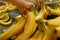 Motion of woman`s hand picking bananas inside superstore