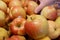 Motion of woman`s hand picking organic ambrosia apple inside supermarket