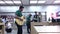 Motion of worker playing guitar inside Apple store