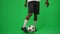 Motivated African American man checking football ball kicking running away leaving green screen. Inspired soccer player