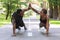 Motivated black couple giving high-five to each other while working out outdoors