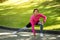 Motivated black woman exercising at public park