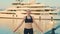Motivated blonde girl doing jumping jacks exercises