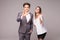 Motivated businessman and woman giving a okay gesture of approval and success as they pose side by side giving the camera big frie