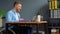 Motivated cheerful disabled freelancer talking on video chat while sitting at office in a wheelchair