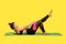 Motivated fitness woman with hair bun in yoga pants training on gym mat, reaching hands to feet stretching muscles