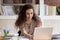 Motivated girl using laptop preparing for exam in library