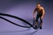 Motivated handsome ambitious man working out with battle ropes at gym