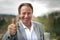 Motivated happy successful businessman giving a thumbs up gesture