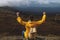 Motivated hiker with raised clenched fists is rejoicing at his climbing