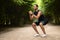 Motivated muscular black man exercising in the park, using band