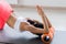 Motivated sporty woman training on mat indoor winter day, using foam roller massager for relaxation, stretching spine muscles,