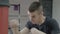 Motivated young male champion boxer hitting fast the punching bag without wearing gloves -