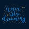 : Motivating inscription in blue letters on a dark blue background. Never stop dreaming. stars and dots around the lettering. Stic